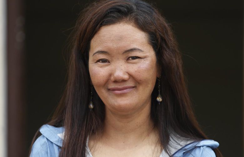 FILE- Nepalese female climber Lhakpa Sherpa talks with Associated Press in Kathmandu, Nepal, May 23, 2018. The Nepali Sherpa woman living in Connecticut scaled Mount Everest Thursday breaking her own record of the most climbs of the world’s highest peak by a female climber, expedition organizers said. (AP Photo/Niranjan Shrestha, File) NE101 NE101