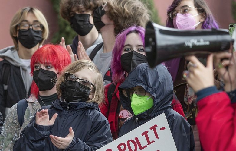 Students applaud a speaker during a protest to end mask requirements, during a rally outside Seattle Public Schools headquarters, Monday, March 21, 2022 in Seattle. 219904