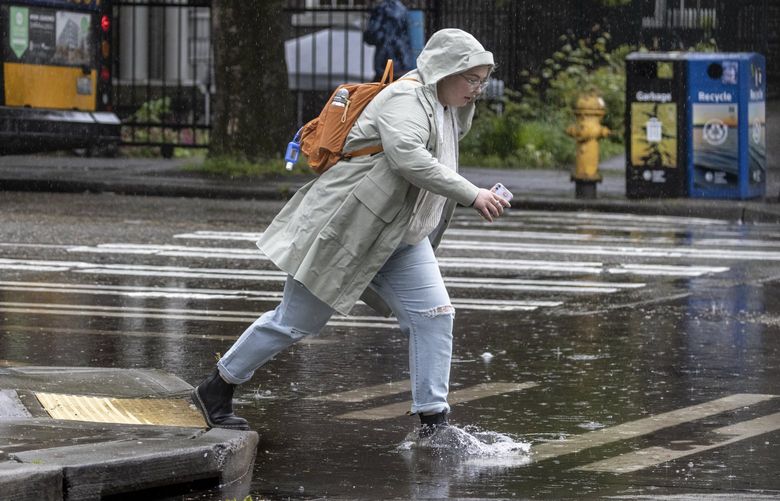 Thursday, May 12, 2022.    Lines Only. LO.  Pedestrian life is a struggle getting down flooded streets on Broadway from the consistent downpour blanketing Seattle.   220394