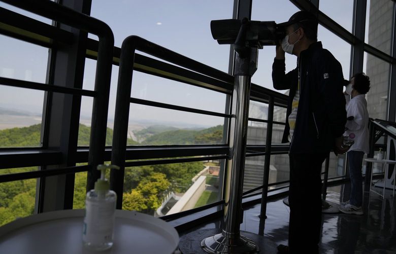 FILE – A bottle of hand sanitizer is placed as visitors use binoculars to see the North Korean side from the unification observatory in Paju, South Korea, Thursday, May 12, 2022. North Korea said Friday six people died and nearly 190,000 are under quarantine following a rapid spread of fever across the nation in recent weeks, a day after it first acknowledged a COVID-19 outbreak in a largely unvaccinated population. (AP Photo/Lee Jin-man, File) NYPH870 NYPH870