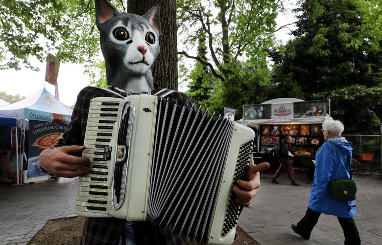 Accordion Cat, his performing name, busk near the fountain at the 48th Annual Northwest Folklife Festival on Friday.
Friday May 24, 2019
LO Linesonly
The 48th Annual Northwest Folklife Festival 210360