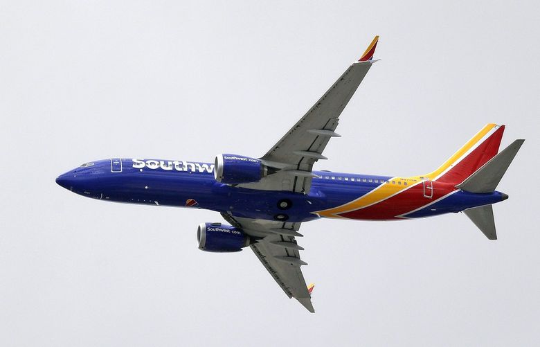 A Southwest Airlines Boeing 737 MAX 8 jet flies over Mesa, Ariz., en route to Phoenix’s Sky Harbor International Airport Wednesday afternoon, March 13, 2019. President Donald Trump said Wednesday that the U.S. is issuing an emergency order grounding all Boeing 737 Max 8 and Max 9 aircraft in the wake of the crash of an Ethiopian Airliner that killed 157 people. (AP Photo/Elaine Thompson)