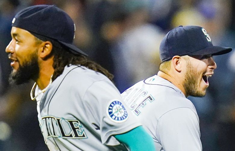 Seattle Mariners’ Ty France, right, celebrates with J.P. Crawford after a baseball game against the New York Mets Friday, May 13, 2022, in New York. The Mariners won 2-1. (AP Photo/Frank Franklin II) NYFF117