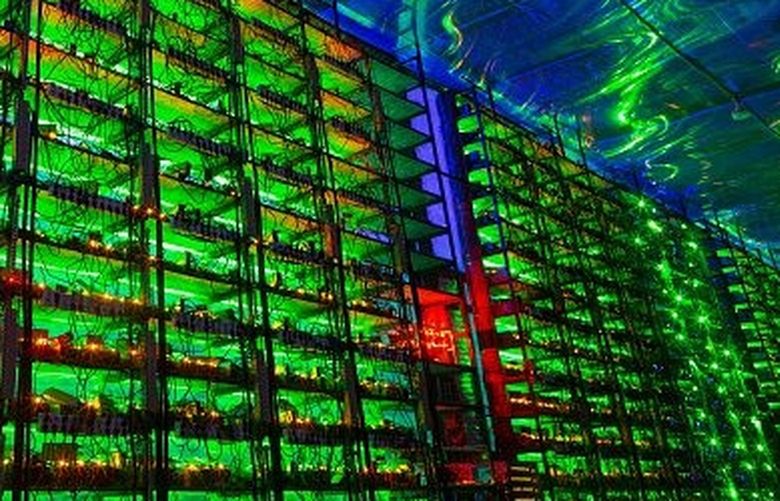 Illuminated mining rigs operate inside racks at the CryptoUniverse cryptocurrency mining farm in Nadvoitsy, Russia, on Thursday, March 18, 2021.  (Bloomberg)