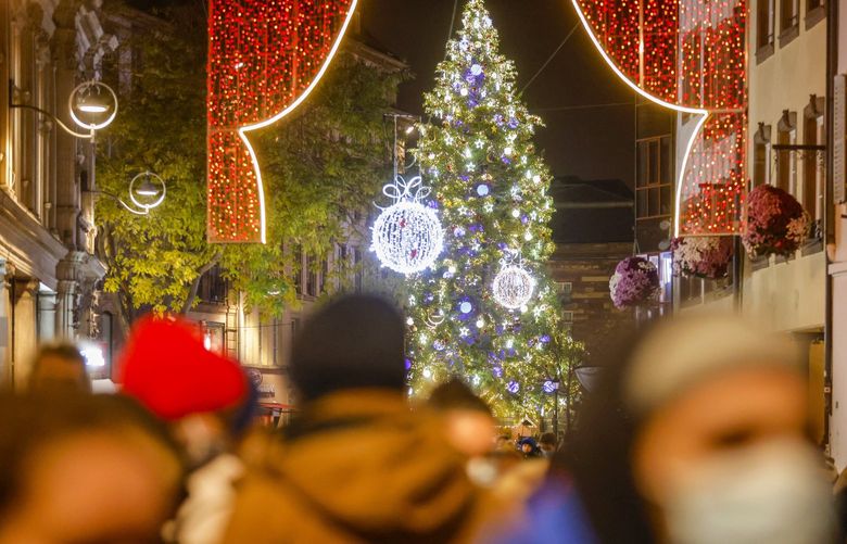 Lights illuminate the Christmas market in Strasbourg, eastern France, Friday, Nov. 26, 2021. France has launched a plan to give COVID-19 booster shots to all adults, as it opted against a further lockdown or curfew to help combat a worrying uptick in infections in the country at Christmas season. (AP Photo/Jean-Francois Badias) MEU108