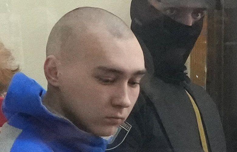 Russian army Sergeant Vadim Shishimarin, 21, is seen behind a glass during a court hearing in Kyiv, Ukraine, Friday, May 13, 2022. The trial of a Russian soldier accused of killing a Ukrainian civilian opened Friday, the first war crimes trial since Moscow’s invasion of its neighbor. (AP Photo/Efrem Lukatsky) TH102 TH102