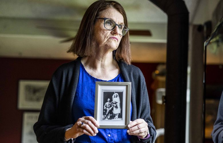 Trish Karn holds a portrait of her grandmother and grandfather in her Kent home on Thursday, May 12, 2022. Karn’s grandmother, Florence Mewes died from an illegal abortion during the Depression.