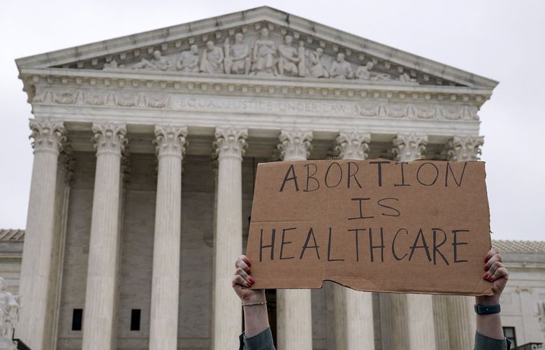 An abortion-rights demonstrator holds a sign outside the Supreme Court following a leaked draft opinion that the Supreme Court has potentially voted to overturn Roe V. Wade, in Washington, May 3, 2022. The Supreme Court on Tuesday confirmed the authenticity of a leaked draft ruling overturning the Roe v. Wade decision establishing a constitutional right to abortion but stressed that it was not final even as the disclosure triggered a political earthquake with potentially broad electoral and legal consequences. (Leigh Vogel/The New York Times) XNYT211 XNYT211