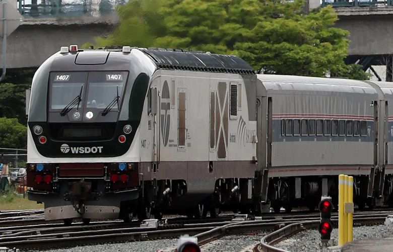 An Amtrak Cascades train from Portland, passing T-Mobile Park, pulls into King Street Station, Tuesday, May 25, 2021 in Seattle. The service restarted Monday. 217237