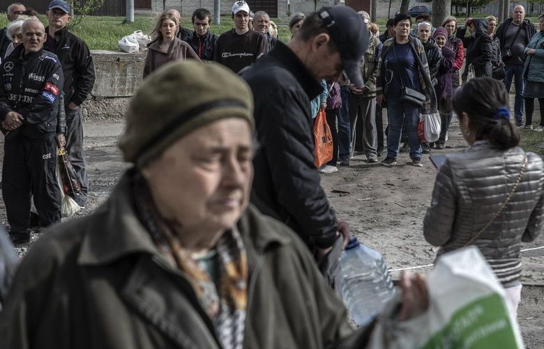 Residents wait to receive humanitarian aid supplies in Kharkiv, Ukraine on Wed., May 11, 2022. A day after Ukraine’s counteroffensive unseated Russian forces from a cluster of towns northeast of the city, the region’s governor said that the Ukrainian efforts had driven Moscow’s forces “even further” from the city. (Finbarr O’Reilly/The New York Times) XNYT58 XNYT58