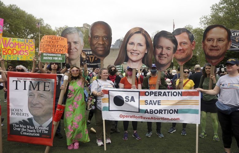 Protesters hold up signs during an abortion rights demonstration, Saturday, May 14, 2022, in New York. Demonstrators are rallying from coast to coast in the face of an anticipated Supreme Court decision that could overturn women’s right to an abortion. (AP Photo/Jeenah Moon) NYJJ103 NYJJ103