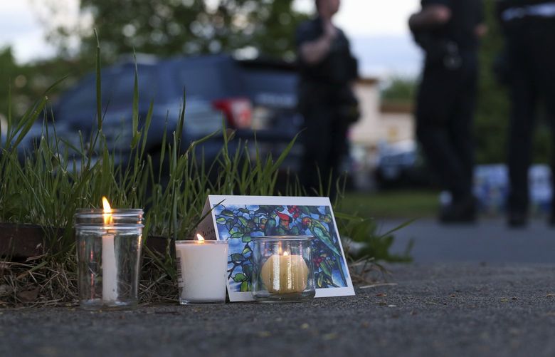 Police walk by a small memorial as they investigate after a shooting at a supermarket on Saturday, May 14, 2022, in Buffalo, N.Y. (AP Photo/Joshua Bessex) NYJB125 NYJB125