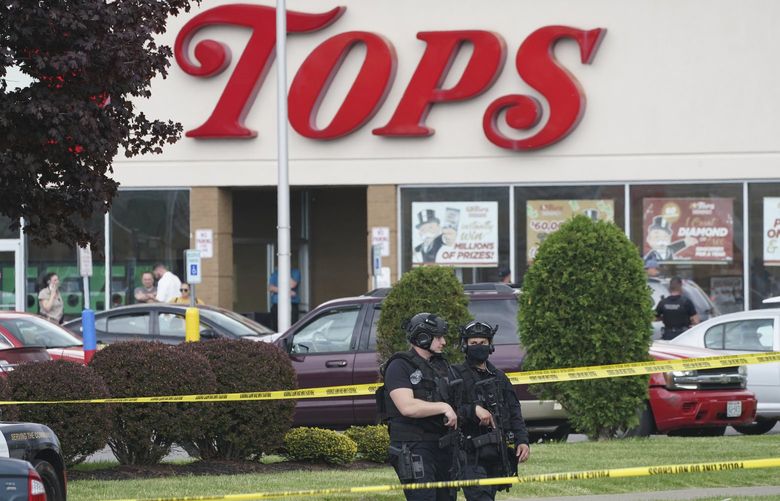 Police secure an area around a supermarket where several people were killed in a shooting, Saturday, May 14, 2022 in Buffalo, N.Y. Officials said the gunman entered the supermarket with a rifle and opened fire. Investigators believe the man may have been livestreaming the shooting and were looking into whether he had posted a manifesto online (Derek Gee/The Buffalo News via AP) NYBUE103 NYBUE103