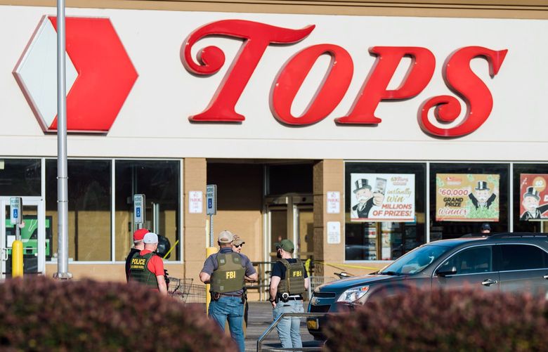 Police and FBI investigators on Monday, May 16, 2022, at the scene of Saturday’s mass shooting at Tops supermarket in Buffalo, N.Y. The Tops supermarket was a hub in a largely Black section of Buffalo; that fact made it the target of a racist gunman. (Gabriela Bhaskar/The New York Times) XNYT129 XNYT129