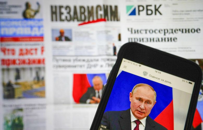 The app of the Russian government newspaper is displayed on an iPhone screen showing Russian President Vladimir Putin during his speech in the Kremlin in Moscow, Russia, Tuesday, Feb. 22, 2022. As the West sounds the alarm about the Kremlin ordering troops into eastern Ukraine and decries an invasion, Russian state media paints a completely different picture. It portrays the move as Moscow coming to the rescue of war-torn areas tormented by Ukraine’s aggression and bringing them much-needed peace. (AP Photo/Alexander Zemlianichenko Jr) XAZ901