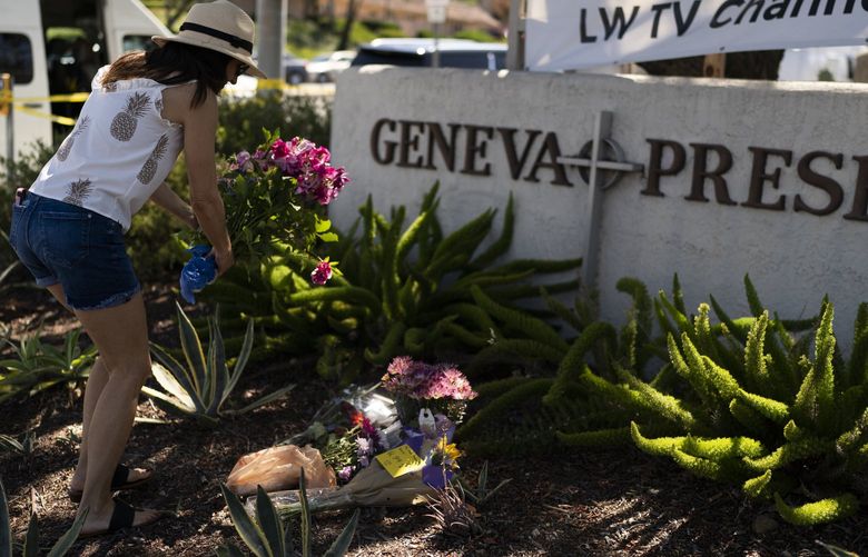 Joanna Garcia, 47, leaves flowers outside Geneva Presbyterian Church to honor victims in Sunday’s shooting at the church in Laguna Woods, Calif., Monday, May 16, 2022. Authorities say a gunman in a deadly attack at the church was a Chinese immigrant motivated by hate for Taiwanese people. (AP Photo/Jae C. Hong) CAJH112 CAJH112