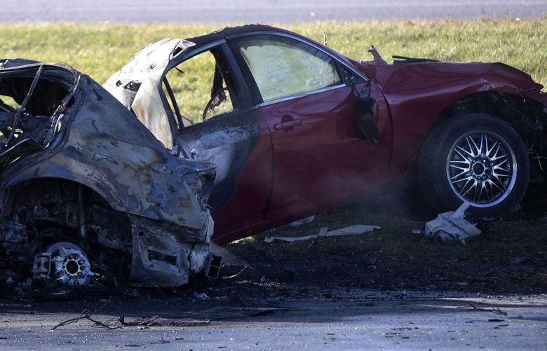 Chicago police officers work at the scene of a fatal car crash in the 5300 block of DuSable Lake Shore Drive Sunday, Dec. 12, 2021. According to police, two male victims were inside a vehicle driving at a high rate of speed and struck a tree. The vehicle caught on fire. Both victims were pronounced dead at area hospitals.