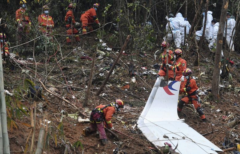 FILE – In this photo released by Xinhua News Agency, workers search through debris at the China Eastern flight crash site in Tengxian County in southern China’s Guangxi Zhuang Autonomous Region on Thursday, March 24, 2022. One month after a China Eastern passenger jet crashed mid-flight, killing all 132 people on board, investigators say they have not determined a cause. (Lu Boan/Xinhua via AP, File)