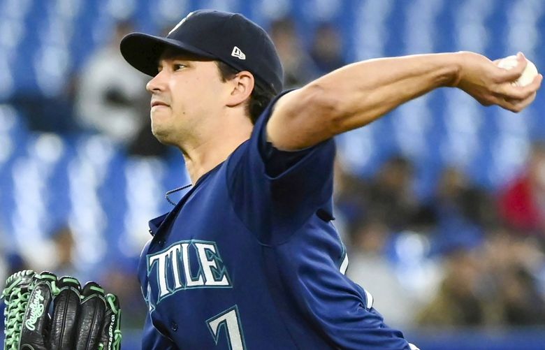 Seattle Mariners starting pitcher Marco Gonzales (7) pitches during the first inning of a baseball game against the Toronto Blue Jays in Toronto on Wednesday, May 18, 2022. (Jon Blacker/The Canadian Press via AP) JCB107