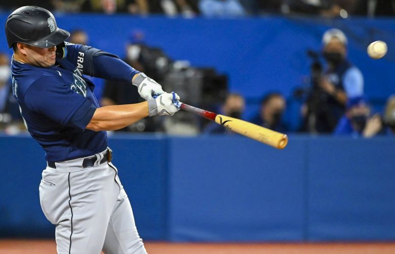 Seattle Mariners’ Ty France hits a single during the first inning of a baseball game against the Toronto Blue Jays in Toronto on Wednesday, May 18, 2022. (Jon Blacker/The Canadian Press via AP) JCB102