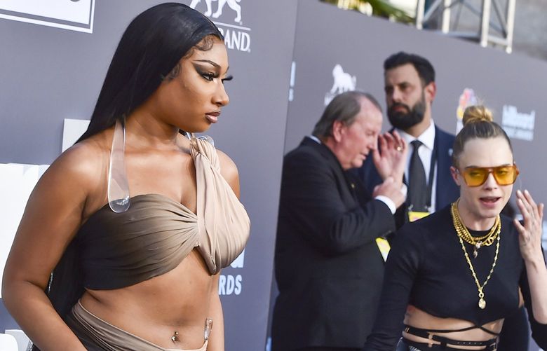 Megan Thee Stallion, left, and Cara Delevingne arrive at the Billboard Music Awards on Sunday, May 15, 2022, at the MGM Grand Garden Arena in Las Vegas. (Photo by Jordan Strauss/Invision/AP) INVW