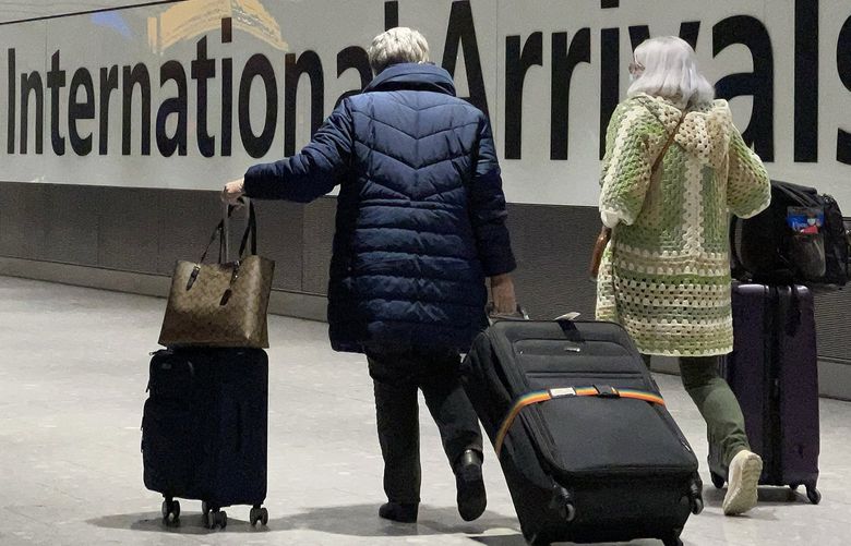 International passengers walk through the arrivals area at Terminal 5 at Heathrow Airport on Nov. 26, 2021, in London, England. (Leon Neal/Getty Images/TNS) 48147164W 48147164W