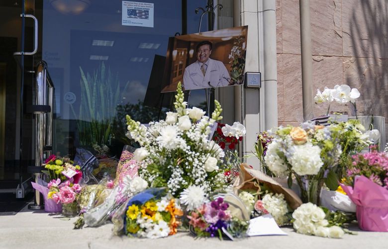 A memorial honoring Dr. John Cheng sits outside his office building on Tuesday, May 17, 2022, in Aliso Viejo, Calif. Cheng, 52, was killed in Sunday’s shooting at Geneva Presbyterian Church. (AP Photo/Ashley Landis) CAAL105 CAAL105
