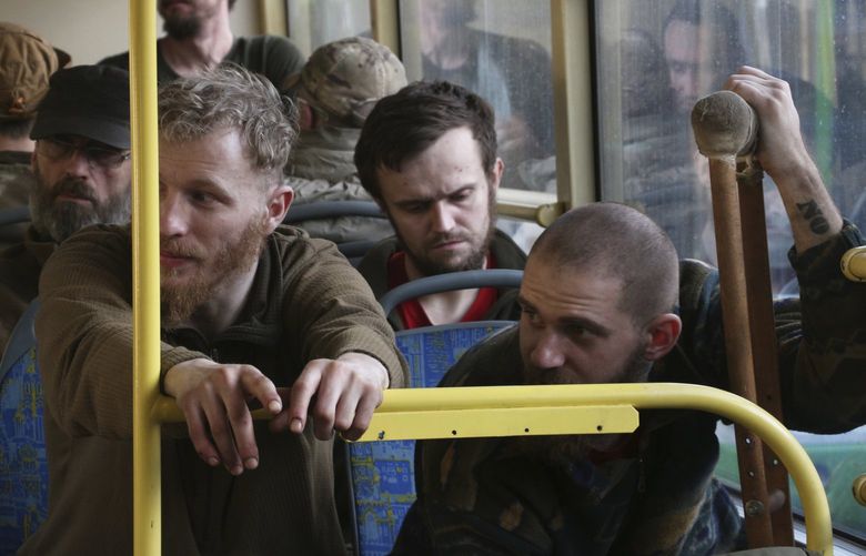 Ukrainian servicemen sit in a bus after they were evacuated from the besieged Mariupol’s Azovstal steel plant, near a prison in Olyonivka, in territory under the government of the Donetsk People’s Republic, eastern Ukraine, Tuesday, May 17, 2022. More than 260 fighters, some severely wounded, were pulled from a steel plant on Monday that is the last redoubt of Ukrainian fighters in the city and transported to two towns controlled by separatists, officials on both sides said. (AP Photo) MAR115 MAR115