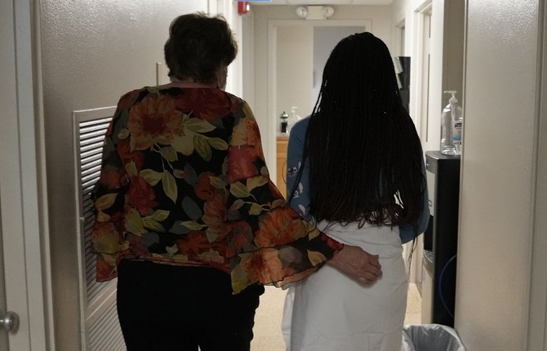 FILE – A 33-year-old mother of three from central Texas is escorted down the hall by clinic administrator Kathaleen Pittman prior to getting an abortion, Oct. 9, 2021, at Hope Medical Group for Women in Shreveport, La. Reproductive rights advocates are planning to open new abortion clinics or expand the capacity of existing ones in states without restrictive abortion laws. (AP Photo/Rebecca Blackwell, File) NYAG601 NYAG601