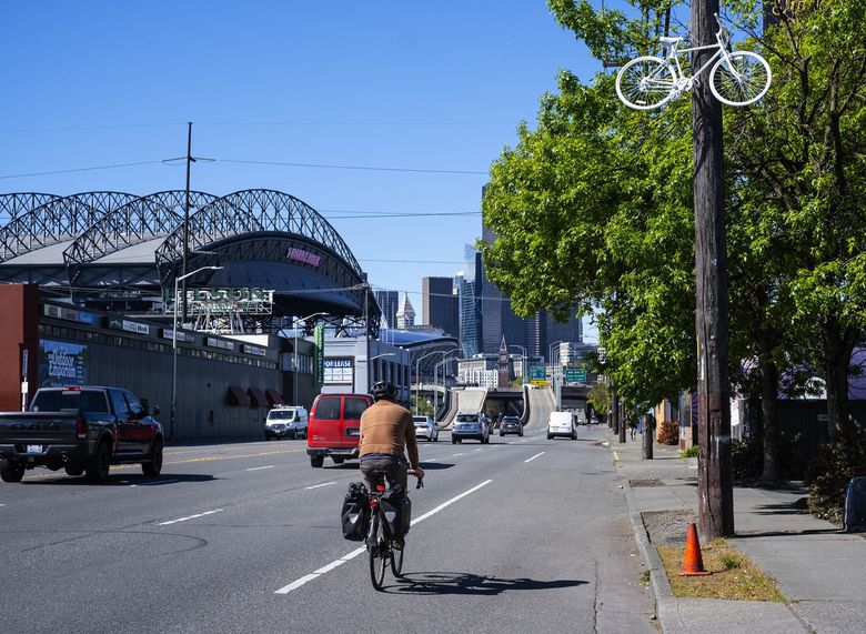 A ghost bike hangs over the spot in Sodo where Gan Hao Li, 73, was struck and killed by a car on May 10. (Dean Rutz / The Seattle Times)