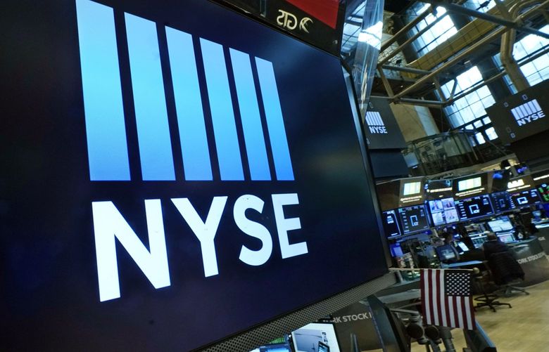  The New York Stock Exchange logo adorn trading posts, on the floor, Wednesday, March 16, 2022.  (AP Photo/Richard Drew, File)
