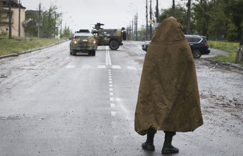 A serviceman of Donetsk People’s Republic militia stands guard not far from the besieged Mariupol’s Azovstal steel plant in Mariupol, in territory under the government of the Donetsk People’s Republic, eastern Ukraine, Wednesday, May 18, 2022. (AP Photo) MAR106 MAR106