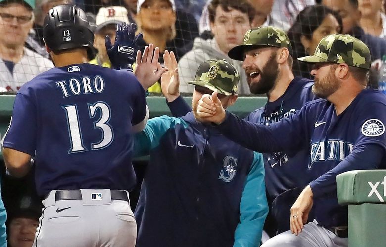 Seattle Mariners’ Abraham Toro (13) is congratulated for his two-run home run during the fifth inning of the team’s baseball game against the Boston Red Sox, Friday, May 20, 2022, in Boston. (AP Photo/Michael Dwyer) MAMD110