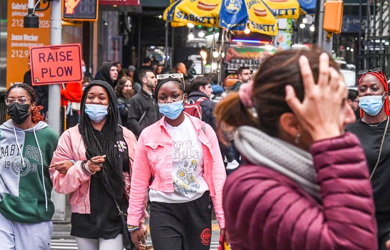 Masked pedestrians at Times Square in Manhattan on May 2, 2022. Mayor Eric Adams said on May 18 that he does not plan to bring back mask mandates for now in New York, after the city entered the high alert level for community spread of the coronavirus this week. (Stephanie Keith/The New York Times) XNYT247