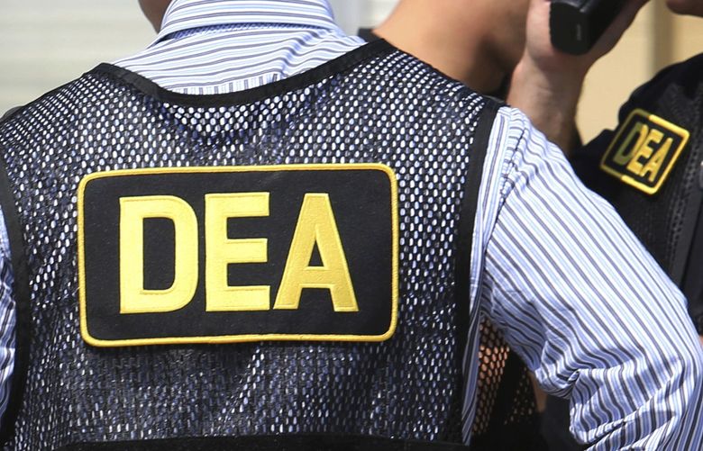 FILE – This June 13, 2016, file photo shows Drug Enforcement Administration agents in Florida. A current U.S. Drug Enforcement Administration agent and a former supervisor in the agency were indicted Friday, May 20, 2022 on federal charges accusing them of leaking confidential law enforcement information to defense lawyers in Florida in exchange for cash and gifts. (Joe Burbank/Orlando Sentinel via AP) FLORL501 FLORL501