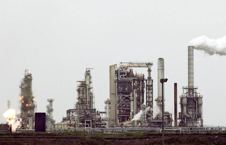 A refinery owned by Andeavor, formerly Tesoro Corp., includes a gas flare flame that is part of normal plant operations, in Anacortes, Wash., in 2010. WATW402