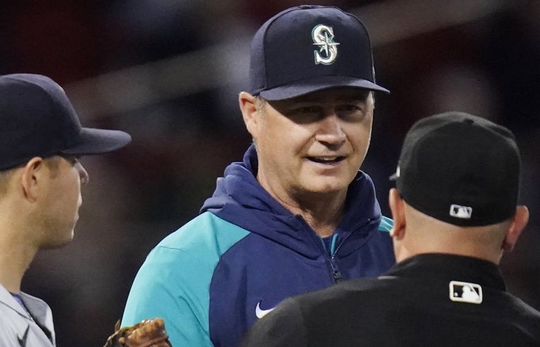Seattle Mariners manager Scott Servais talks with umpires during during a pitching change in the sixth inning of the team’s baseball game against the Boston Red Sox at Fenway Park, Thursday, May 19, 2022, in Boston. (AP Photo/Charles Krupa) MACK114 MACK114