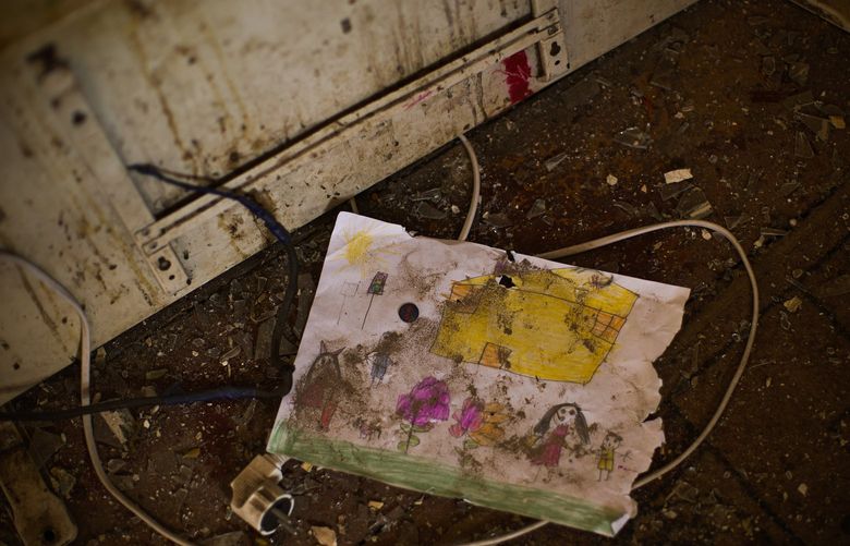 A child’s drawing lays on the floor of Iryna Martsyniuk’s home, heavily damaged after a Russian bombing in Velyka Kostromka village, Ukraine, Thursday, May 19, 2022. Martsyniuk and her three young children were at home when the attack occurred in the village, a few kilometres from the front lines, but they all survived unharmed. (AP Photo/Francisco Seco) FS104 FS104
