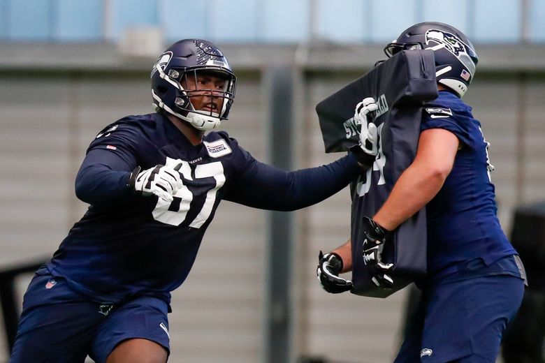 Rookie offensive lineman Charles Cross goes through a blocking drill during Seahawks rookie mini camp May 7. (Jennifer Buchanan / The Seattle Times)