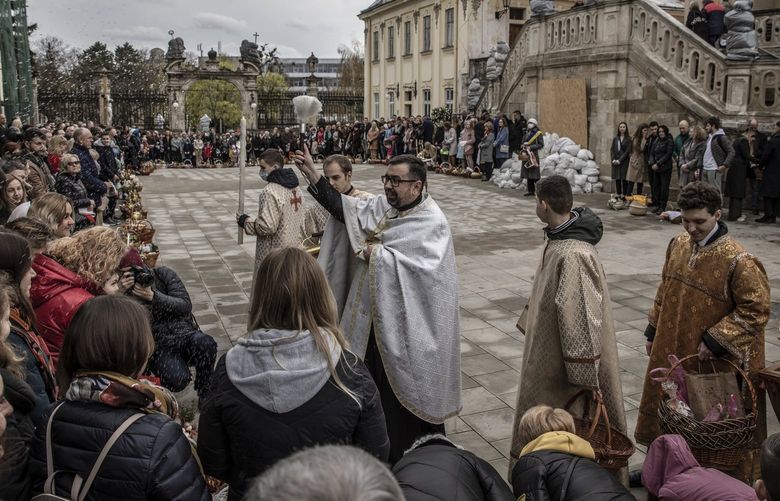 FILE – Ukrainian Orthodox Christian faithful at a blessing ceremony on the day before Orthodox Easter, outside St.George’s Cathedral in Lviv, Ukraine, April 23, 2022. Moscow’s invasion of eastern Ukraine in 2014 led the already unhappy Ukrainian Orthodox Church to break from centuries of jurisdiction under the Moscow-based Russian Orthodox Church, costing it about a third of its parishes. (Finbarr O’Reilly/The New York Times) XNYT27 XNYT27