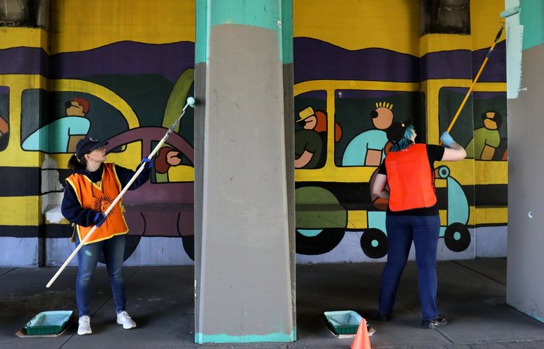 Volunteers Kaylynn Burke (CQ), left, and Rowan Finkle work to restore the extensive  Aurora Bridge Mural (CQ, it’s title) by Patrick Gabriel from 1996 on the Seattle Day of Service.  About a dozen joined the effort  under the north end of the Aurora Bridge on North 38th Street. The Fremont Arts Council organized this Day of Service effort to refresh the work on the northern retaining wall of the Highway 99/Aurora Avenue underpass at North 38th Street.  

Ref to more photos online

 First Seattle Day of Service

LO Linesonly
Saturday May 21, 2022 220385