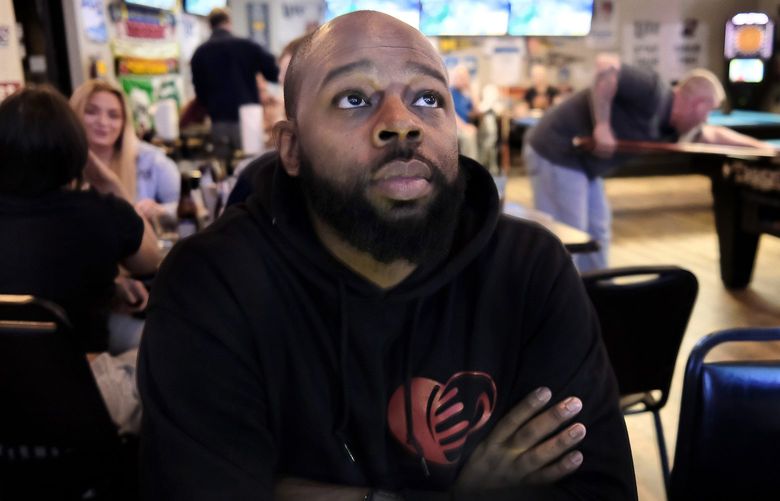 Evansville city council member Alex Burton watches sports at a local bar in his hometown, where Black people still feel marginalized. MUST CREDIT: Washington Post photo by Michael S. Williamson