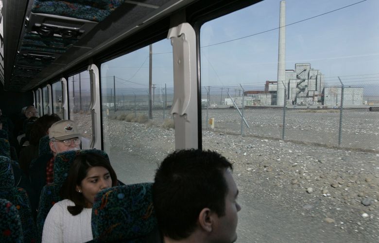 FILE – Guests on a bus tour of the Hanford Nuclear Reservation view the decommissioned plutonium-producing B reactor, April 3, 2008, near Richland, Wash. The federal government is moving forward with the cost-saving “cocooning” of eight plutonium production reactors at Hanford that will place them in a state of long-term storage for decades to allow radiation inside to dissipate until they can be dismantled and buried. (AP Photo/Ted S. Warren, File)