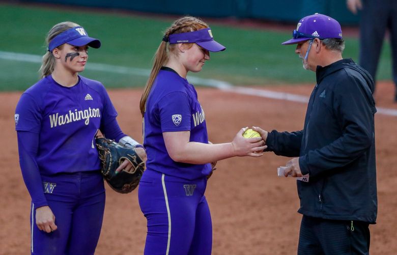 Husky Softball Stadium – NCAA regionals – University of Washington Huskies vs. University of Texas – Game 2 – 052222
Washington starting pitcher Gabbie Plain hands the ball over to pitching coach Lance Glasoe as she is pulled from the game during the seventh inning Sunday, May 22, 2022, in Seattle, Wash. 220462