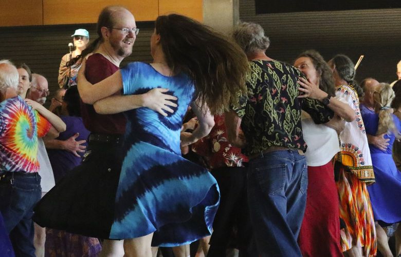 Contra dancers, including Martin McClure and Andrea Nettleton, front, move to the music in the Fisher Pavillion.
47th Northwest Folklife Festival at Seattle Center, Friday May 25, 2018.
LO Linesonly