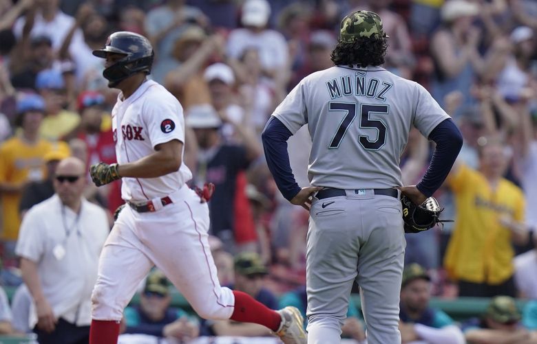 Seattle Mariners’ Andres Munoz (75) watches as Boston Red Sox’s Franchy Cordero, left, runs the bases toward home after hitting a grand slam in the tenth inning of a baseball game Sunday, May 22, 2022, in Boston. (AP Photo/Steven Senne) MASR115 MASR115