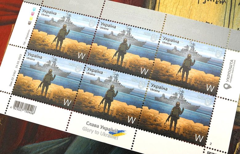 Boris Groh, age 27, is a digital artist who created the famous drawing of a Russian ship and Ukrainian man, used on a stamp. The stamp sold out instantly and is now being sold for over $500 a piece. These stamp are being sold at by a man at a curios flee market in Lviv on May 1, 2022, along with other items. (Carolyn Cole/Los Angeles Times/TNS) 48051886W 48051886W