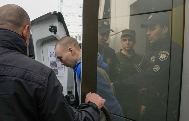 Police escort Russian Sgt. Vadim Shishimarin after a Ukrainian court sentenced him to life in prison in Kyiv, Ukraine, Monday, May 23, 2022. The court sentenced the 21-year-old soldier for killing a Ukrainian civilian, in the first war crimes trial held since Russia’s invasion. (AP Photo/Natacha Pisarenko) XRM111 XRM111
