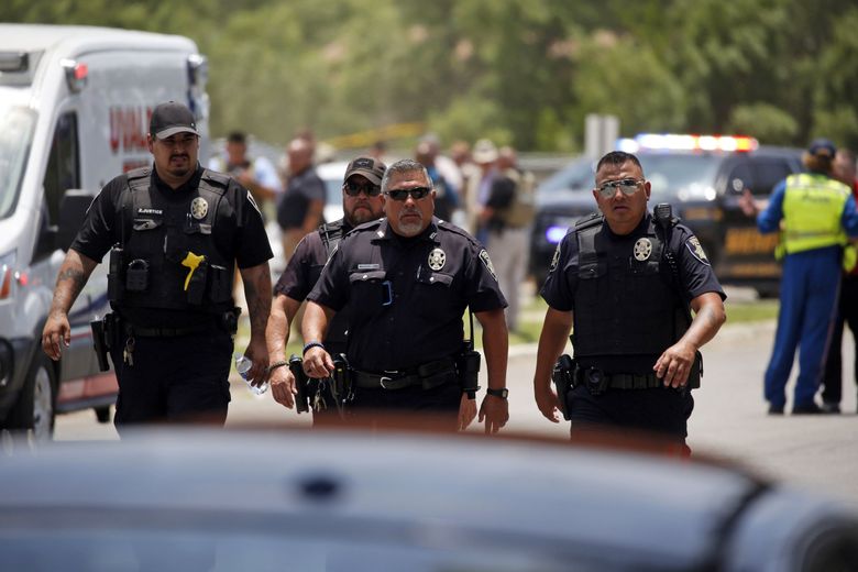 Police walk near Robb Elementary School following a shooting, Tuesday, May 24, 2022, in Uvalde, Texas.  (Dario Lopez-Mills / The Associated Press)