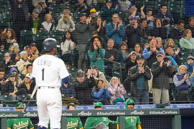 Fans greet Seattle Mariners’ Kyle Lewis during the third inning as he approaches the plate for his first at-bat since being called up earlier in the day from the minors. Lewis grounded out for the at-bat. (Ted S. Warren / AP)